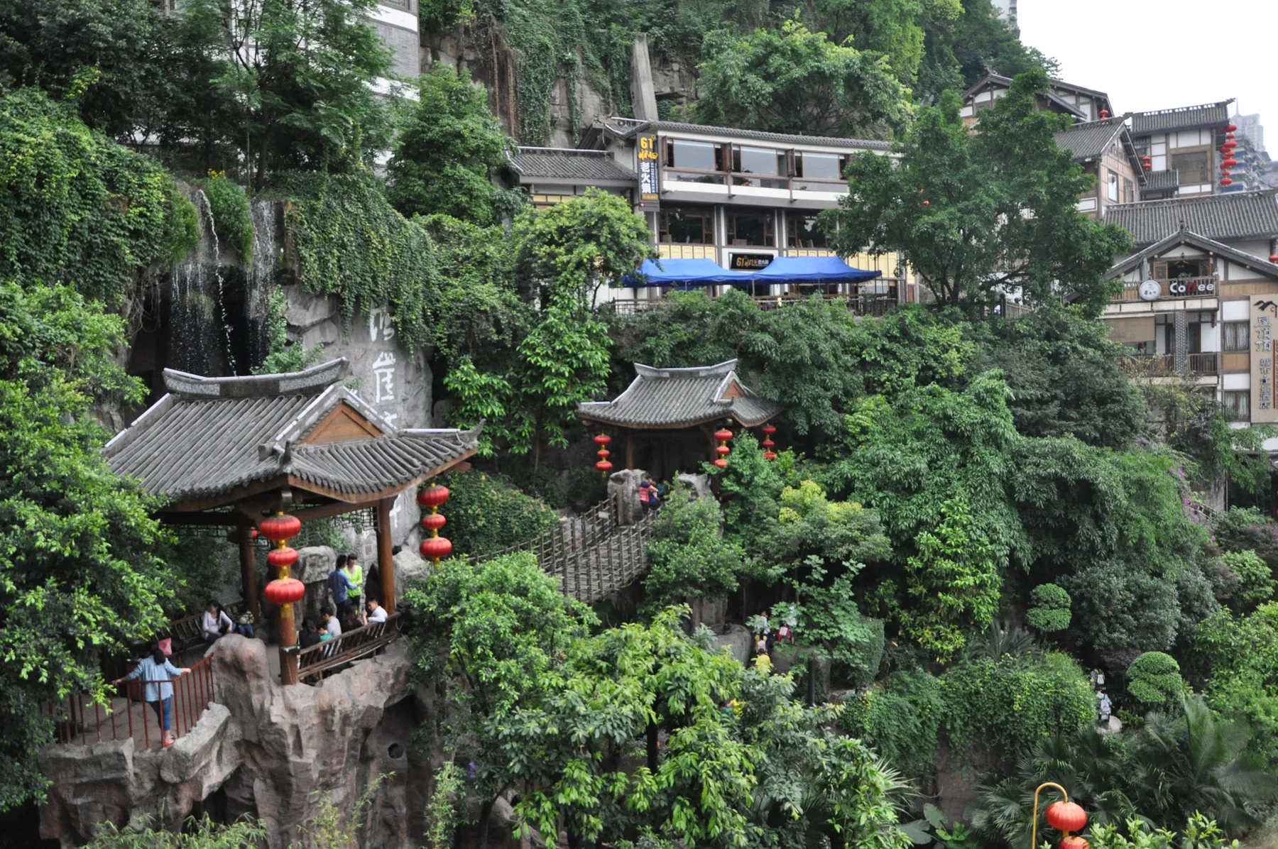 Steep stairs, hillside houses and dense vegetation showing Chongqing's vertical street geography